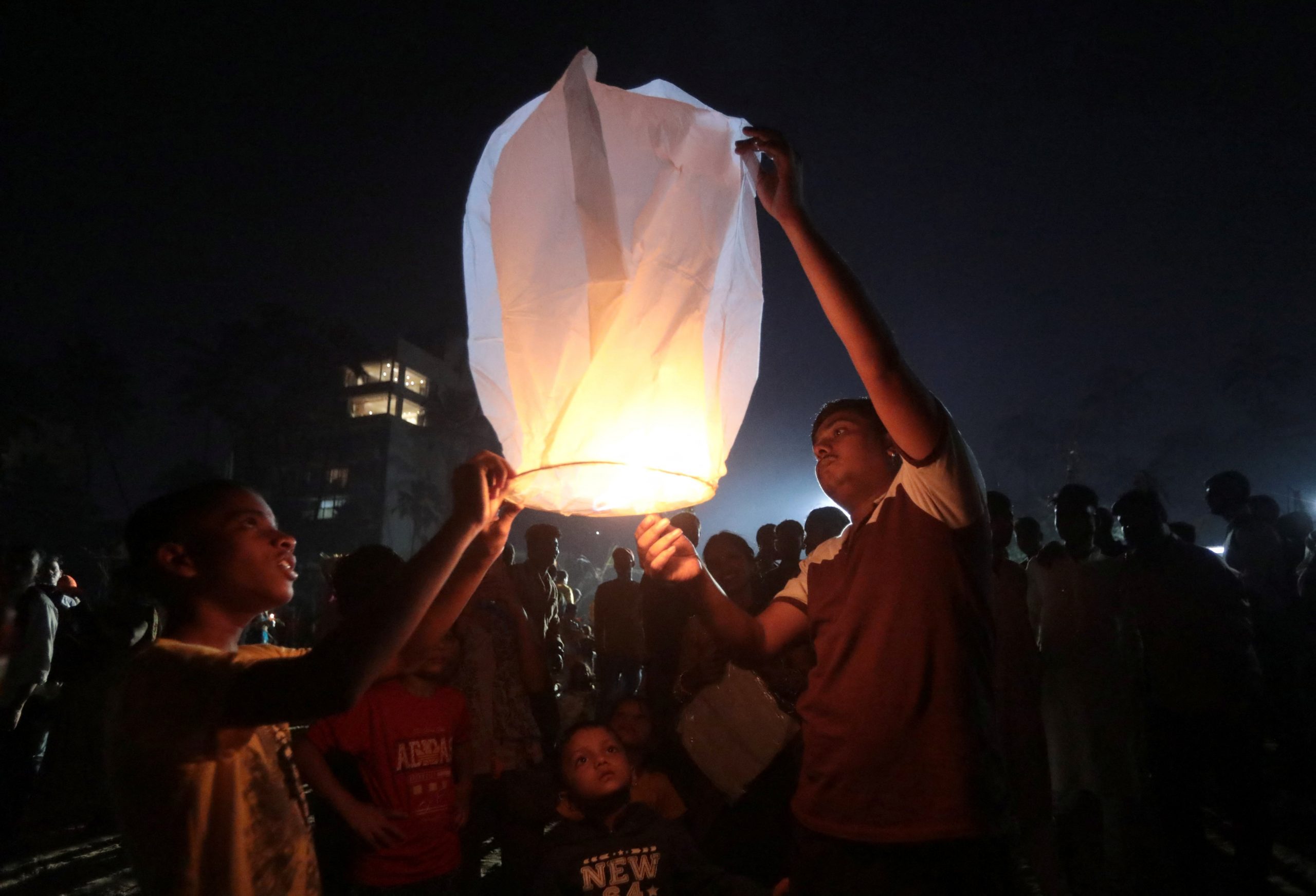 During Chhath Puja in Mumbai, devotees release lanterns after worshiping the Sun god.