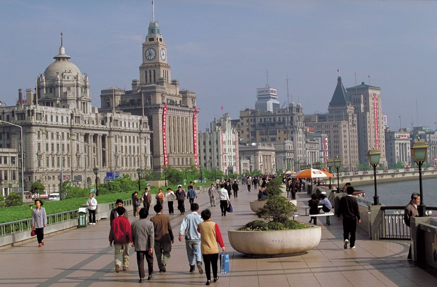 Chinese people walking besides Huangpu river in Shanghai 
